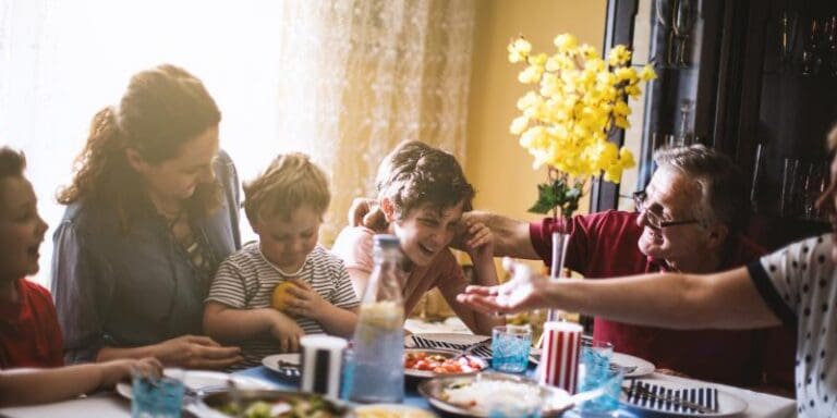 family at dinner table laughing